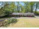 Beautiful one-story brick home with covered entry, surrounded by mature trees at 629 Concord Sw Rd, Smyrna, GA 30082