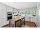 Bright kitchen featuring white cabinetry, stainless steel appliances, and butcher block island with seating at 629 Concord Sw Rd, Smyrna, GA 30082