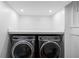 Bright laundry room featuring front-loading washer and dryer, and neutral color palette at 629 Concord Sw Rd, Smyrna, GA 30082