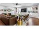 Cozy living room featuring a comfortable brown sofa, hardwood floors, built-in shelves, and a ceiling fan at 629 Concord Sw Rd, Smyrna, GA 30082