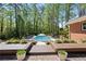 Inviting backyard pool surrounded by lush landscaping and lounge chairs, perfect for relaxation and entertaining at 629 Concord Sw Rd, Smyrna, GA 30082