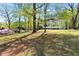 Spacious front lawn with mature trees providing shade and privacy to the home at 629 Concord Sw Rd, Smyrna, GA 30082