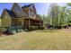 The house includes a backyard with a screened-in porch and manicured landscaping, with an outdoor patio at 1000 Holly St, Canton, GA 30114