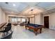 Finished basement with a pool table, wet bar with chairs, comfortable couch and a large window at 1000 Holly St, Canton, GA 30114