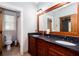 Elegant bathroom featuring double sinks, granite countertops, and a framed mirror at 1000 Holly St, Canton, GA 30114