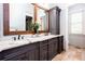 Stylish bathroom featuring dual sinks, large mirror, granite countertop, and ample storage at 1000 Holly St, Canton, GA 30114