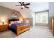 Comfortable bedroom with a wooden bed frame, side tables with lamps, and a bright window at 1000 Holly St, Canton, GA 30114