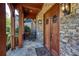 Inviting front porch featuring stone accents, a rustic wood door, and warm lighting at 1000 Holly St, Canton, GA 30114