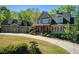 Charming two-story home with a well-kept lawn and beautifully landscaped front yard at 1000 Holly St, Canton, GA 30114