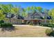 Spacious two-story home featuring a three-car garage and a well-manicured front yard at 1000 Holly St, Canton, GA 30114