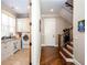 Hallway featuring a staircase and laundry room at 1000 Holly St, Canton, GA 30114