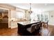 Bright kitchen featuring a large granite island, modern lighting fixtures, and hardwood floors at 1000 Holly St, Canton, GA 30114