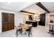 Spacious open-concept kitchen and dining area features stainless steel appliances, dark cabinetry, and a wooden table at 1000 Holly St, Canton, GA 30114