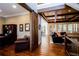 Open-concept living area with hardwood floors, wooden beams, and a view to the dining room at 1000 Holly St, Canton, GA 30114