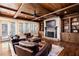 Comfortable living room featuring hardwood floors, a fireplace, and built-in bookshelves at 1000 Holly St, Canton, GA 30114