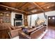 Spacious living room with wood-beamed ceiling, fireplace and beautiful hardwood floors at 1000 Holly St, Canton, GA 30114