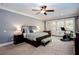 Spacious main bedroom with neutral walls, ceiling fan, and adjacent workout area at 1000 Holly St, Canton, GA 30114