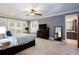 Bright main bedroom featuring large windows, tray ceiling, and ensuite bathroom at 1000 Holly St, Canton, GA 30114
