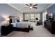Large bedroom with neutral walls, ceiling fan, access to deck and workout area at 1000 Holly St, Canton, GA 30114
