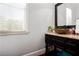 Stylish powder room with elegant vanity, stone sink, granite countertop, and window at 1000 Holly St, Canton, GA 30114