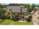 A lush, green backyard surrounds this tan home with gray roof at 265 Lily Cove Dr, Loganville, GA 30052