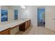 Spacious bathroom with a double sink vanity and adjacent bedroom view at 265 Lily Cove Dr, Loganville, GA 30052