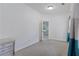 Neutral bedroom featuring carpet flooring, a window, and an attached bathroom at 265 Lily Cove Dr, Loganville, GA 30052
