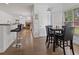 Open-concept dining area with access to the kitchen and a fireplace at 265 Lily Cove Dr, Loganville, GA 30052