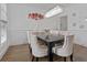 Elegant dining room with a modern chandelier, decorative wall art, and seating for eight at 265 Lily Cove Dr, Loganville, GA 30052