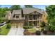 Beautiful brick home featuring a two-car garage, upper and lower porches, and mature landscaping at 265 Lily Cove Dr, Loganville, GA 30052