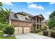 Lovely brick home with an attached two-car garage, a columned porch, and a well-maintained lawn at 265 Lily Cove Dr, Loganville, GA 30052