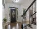Elegant foyer features a stylish front door, hardwood floors, and staircase with decorative iron railings at 265 Lily Cove Dr, Loganville, GA 30052