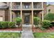 Welcoming front entrance with a decorative door, classic columns, and lush landscaping at 265 Lily Cove Dr, Loganville, GA 30052