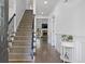 Welcoming hallway with a view of the staircase and living area, featuring hardwood floors at 265 Lily Cove Dr, Loganville, GA 30052