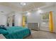 Main bedroom featuring a bed with teal covers and lots of windows at 265 Lily Cove Dr, Loganville, GA 30052