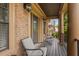 Charming porch with rocking chairs, brick columns, and a wooden floor at 265 Lily Cove Dr, Loganville, GA 30052