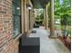 Relaxing front porch with seating, stately columns, and beautiful landscaping at 265 Lily Cove Dr, Loganville, GA 30052