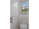 Cozy powder room with toilet and window at 265 Lily Cove Dr, Loganville, GA 30052