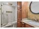 Bathroom featuring a granite countertop, framed mirror, walk-in shower and vanity at 2740 Stonehill Way, Cumming, GA 30041
