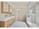 Bright bathroom features a double vanity and a glass enclosed shower at 2740 Stonehill Way, Cumming, GA 30041