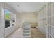 Walk-in closet with custom shelving, drawers, and a center glass island at 2740 Stonehill Way, Cumming, GA 30041