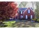 Beautiful two-story brick home with well-manicured lawn and mature landscaping at 2740 Stonehill Way, Cumming, GA 30041