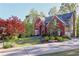 Charming two-story brick home with lush landscaping and a curved driveway at 2740 Stonehill Way, Cumming, GA 30041