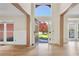 Bright foyer with hardwood floors and a view to the front yard with lush plantings at 2740 Stonehill Way, Cumming, GA 30041