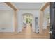 Inviting foyer with hardwood floors and view to the living room with an open archway at 2740 Stonehill Way, Cumming, GA 30041