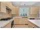 Well-appointed kitchen with custom cabinets, stone countertops, and stainless steel appliances at 2740 Stonehill Way, Cumming, GA 30041