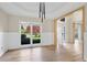 Open-concept living room with hardwood floors and a large window overlooking the yard at 2740 Stonehill Way, Cumming, GA 30041