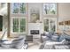 Bright living room with fireplace, large windows, and comfortable seating area. Lots of natural light at 2740 Stonehill Way, Cumming, GA 30041