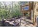 Spacious brick patio with stone pillars and view of the wooded backyard at 2740 Stonehill Way, Cumming, GA 30041