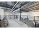 Modern loft bedroom with metal railing overlooking lower level, exposed ductwork and concrete floors at 572 Edgewood Ne Ave # 301, Atlanta, GA 30312
